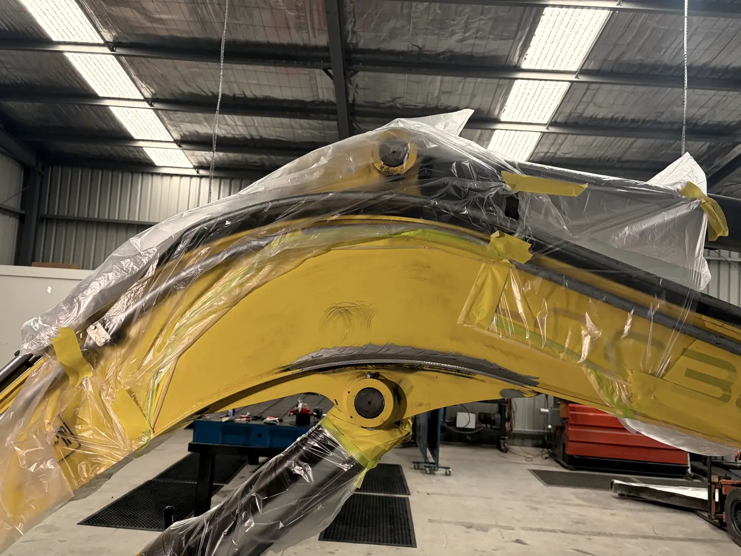 Excavator boom crack ground out and prepped for welding repair