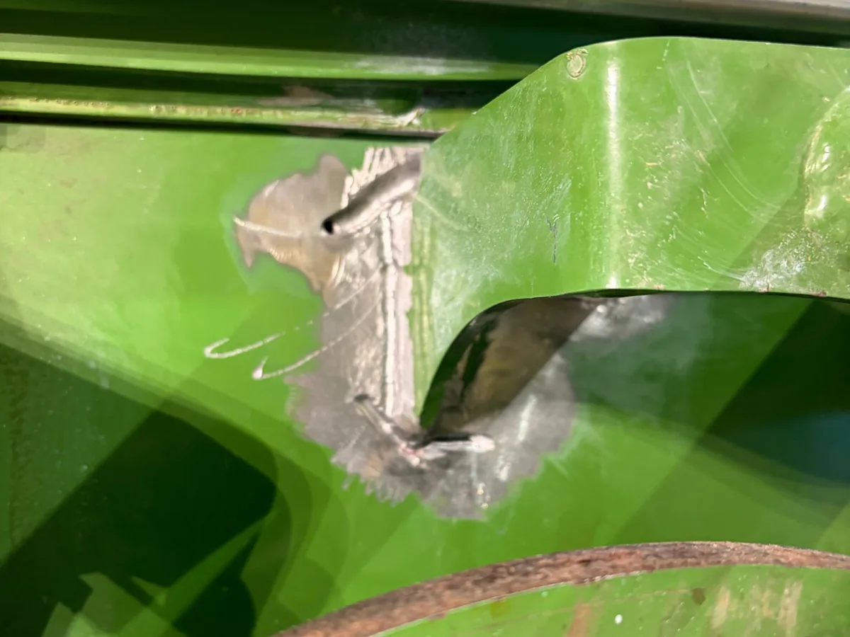 First crack ground out and MIG welded beside the bracket on a hay baler near Prairie