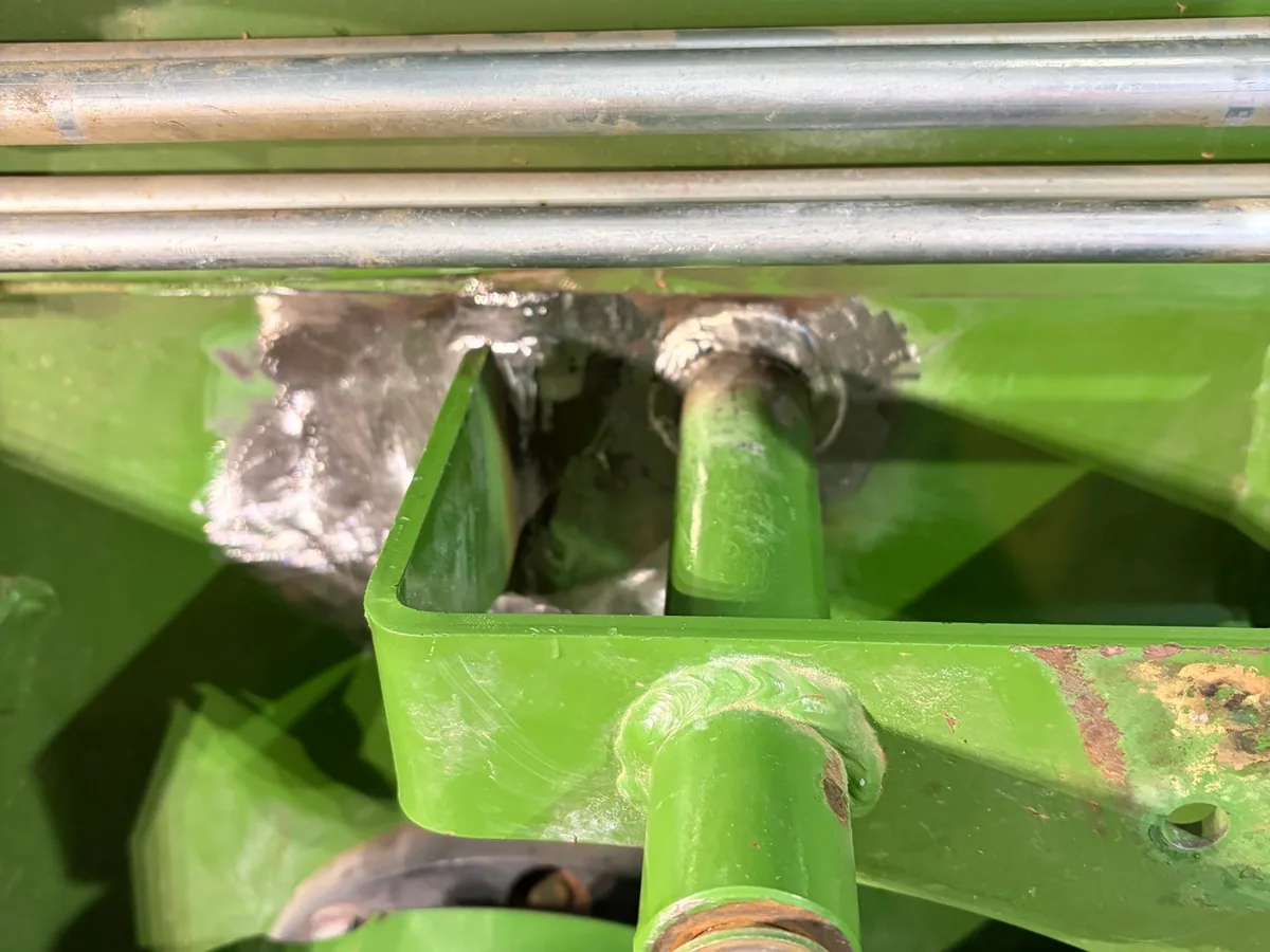 Finished, dressed welds in bare metal on a repaired hay baler near Prairie, ready for paint