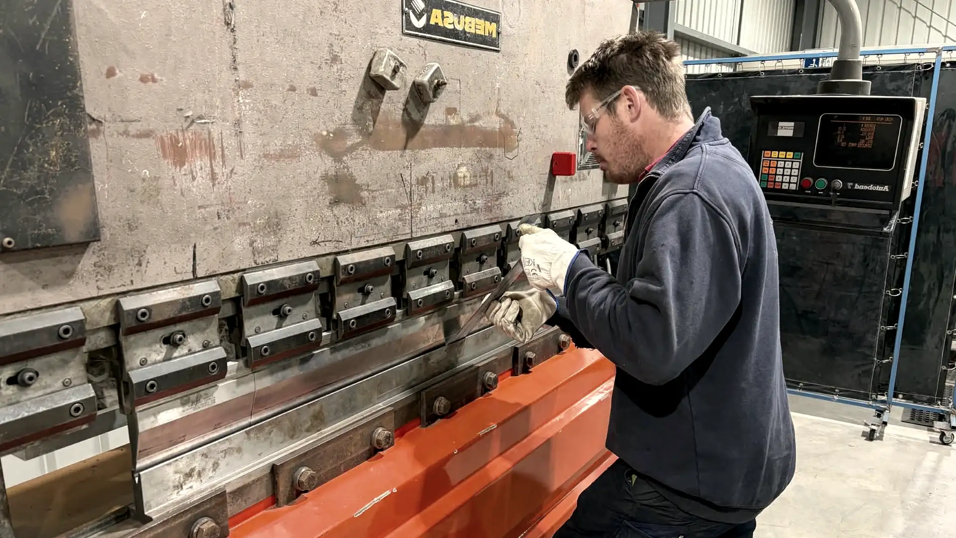 Troy Hutchins operating the press brake at the Midland Metalworks workshop