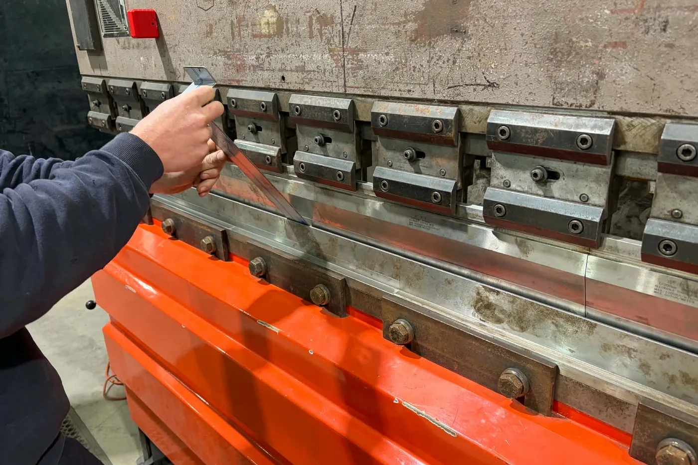 Checking a bend angle on the brake press at the Golden Square workshop