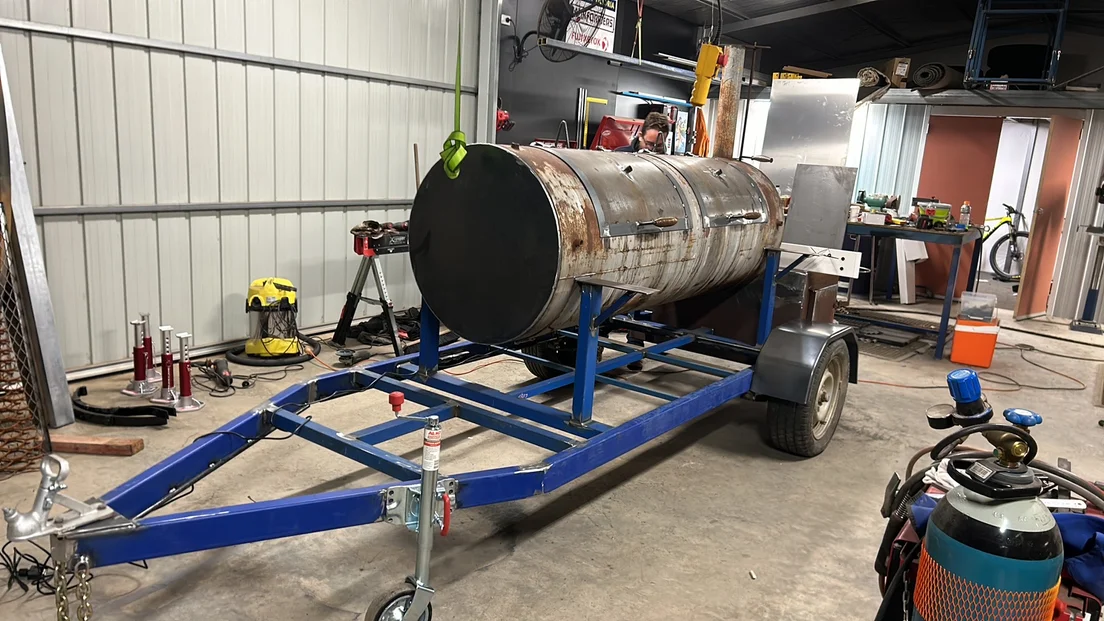 Troy's custom transportable meat smoker mounted on its trailer in the MMW workshop