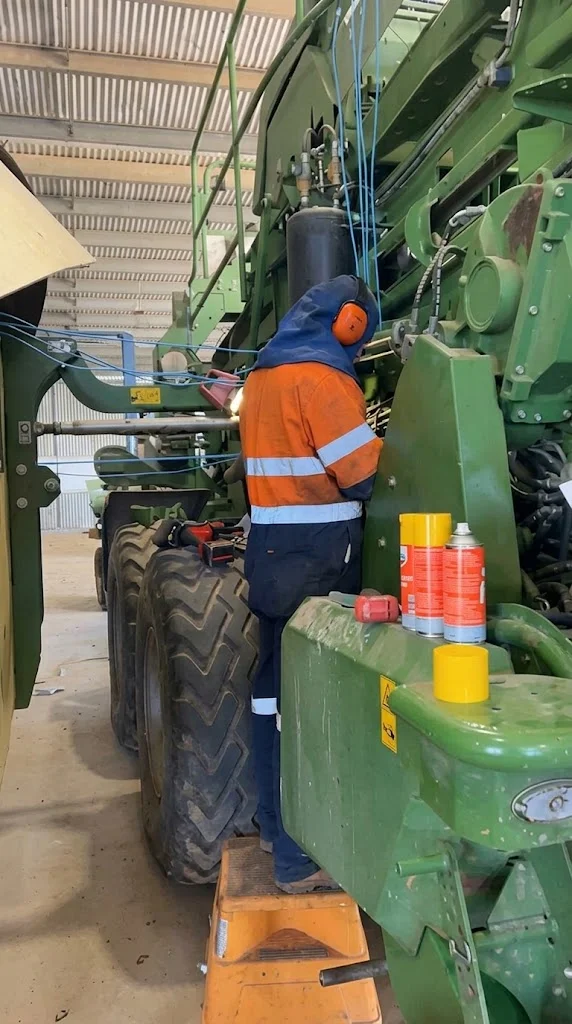 Troy carrying out an on-site repair to a mobile hay baling machine