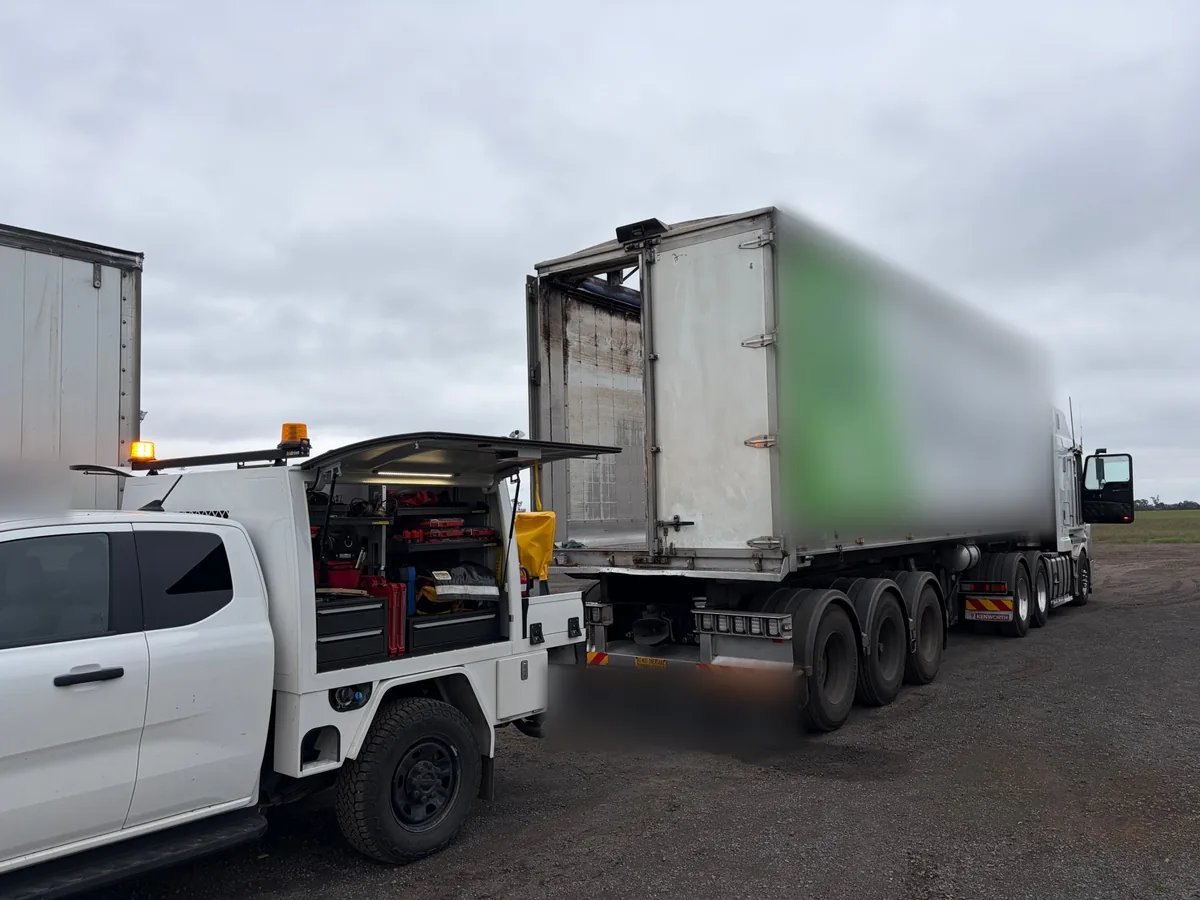 Troy’s ute with its canopy open beside an aluminium semi-trailer and prime mover in Newbridge